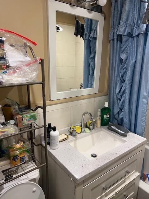 1428 S St Louis Ave, Chicago, IL 60623 - bathroom featuring vanity, tasteful backsplash, and toilet