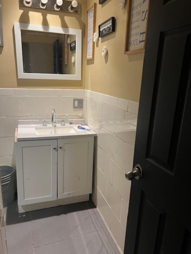 1428 S St Louis Ave, Chicago, IL 60623 - half bathroom with tile walls, wainscoting, vanity, tile patterned floors, and toilet