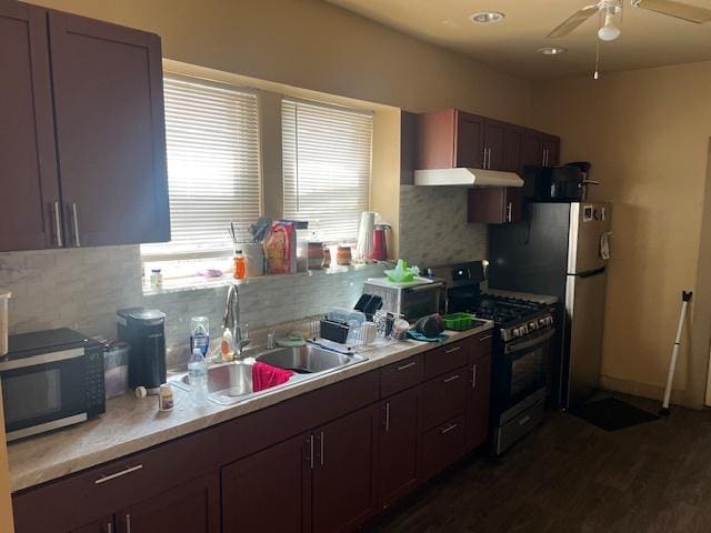 1428 S St Louis Ave, Chicago, IL 60623 - kitchen with stainless steel range with gas stovetop, a sink, under cabinet range hood, and decorative backsplash