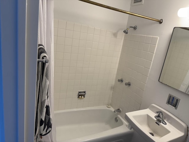 bathroom featuring a sink and shower / tub combo
