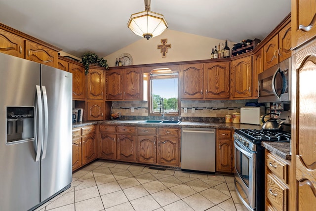 403 Tonelli Trl, Lockport, IL 60441 - kitchen featuring appliances with stainless steel finishes, dark countertops, a sink, lofted ceiling, and brown cabinets