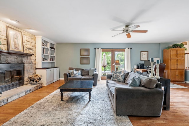 403 Tonelli Trl, Lockport, IL 60441 - living room featuring ceiling fan, light wood-style flooring, and a stone fireplace