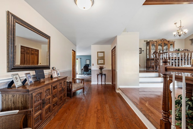 403 Tonelli Trl, Lockport, IL 60441 - hall featuring dark wood finished floors, a chandelier, and wainscoting