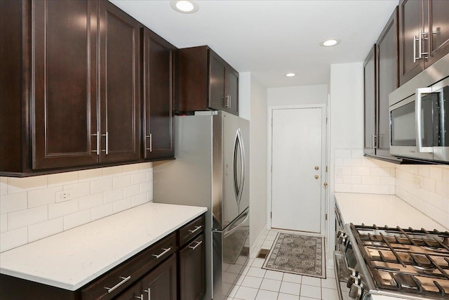 1608 W Ethans Glen Dr, Palatine, IL 60067 - kitchen with stainless steel appliances, dark brown cabinets, recessed lighting, light tile patterned floors, and tasteful backsplash