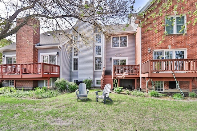 1608 W Ethans Glen Dr, Palatine, IL 60067 - back of property with a chimney, a wooden deck, and a lawn