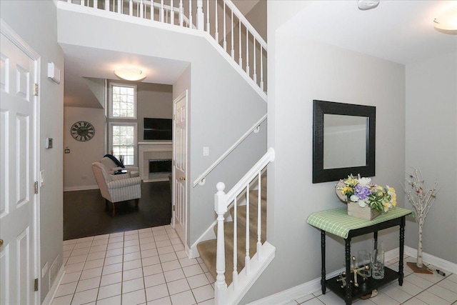1608 W Ethans Glen Dr, Palatine, IL 60067 - foyer with stairway, a fireplace, tile patterned flooring, and baseboards