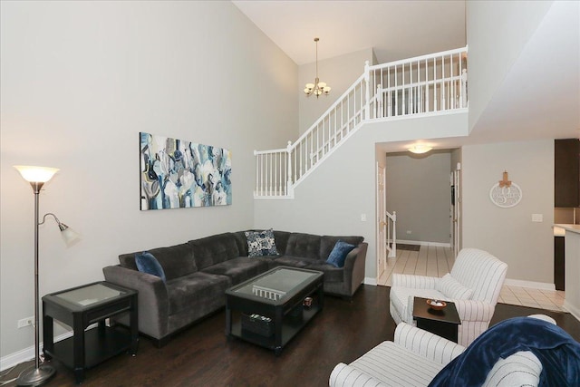 1608 W Ethans Glen Dr, Palatine, IL 60067 - living room featuring a high ceiling, a chandelier, wood finished floors, baseboards, and stairway