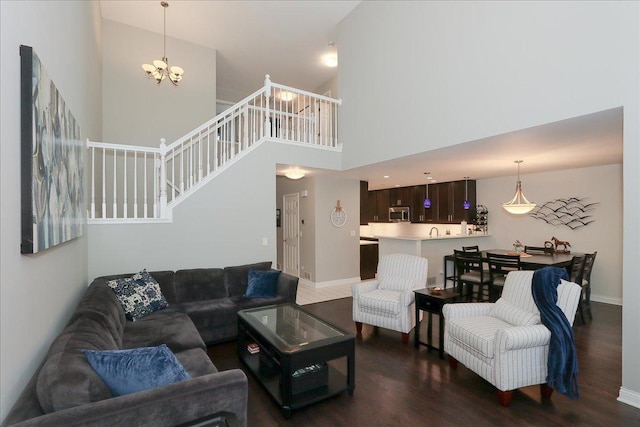 1608 W Ethans Glen Dr, Palatine, IL 60067 - living room with dark wood-style floors, a high ceiling, a chandelier, stairs, and baseboards