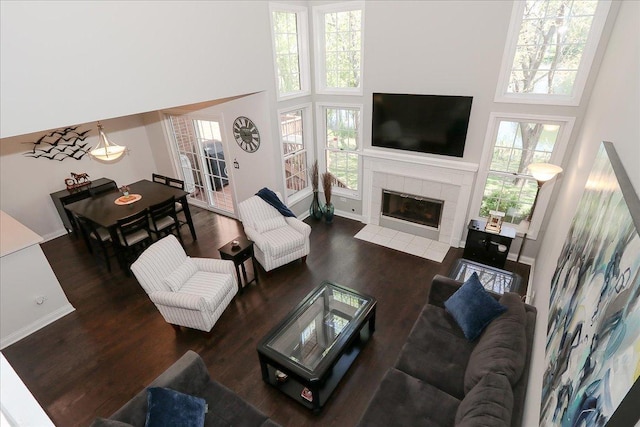 1608 W Ethans Glen Dr, Palatine, IL 60067 - living room with a high ceiling, a tile fireplace, plenty of natural light, wood finished floors, and baseboards