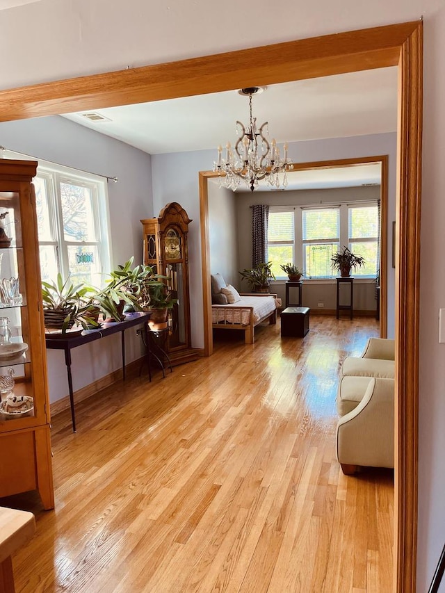 1723 N Richmond St, Chicago, IL 60647 - living area featuring a chandelier, light wood-style flooring, beam ceiling, and baseboards