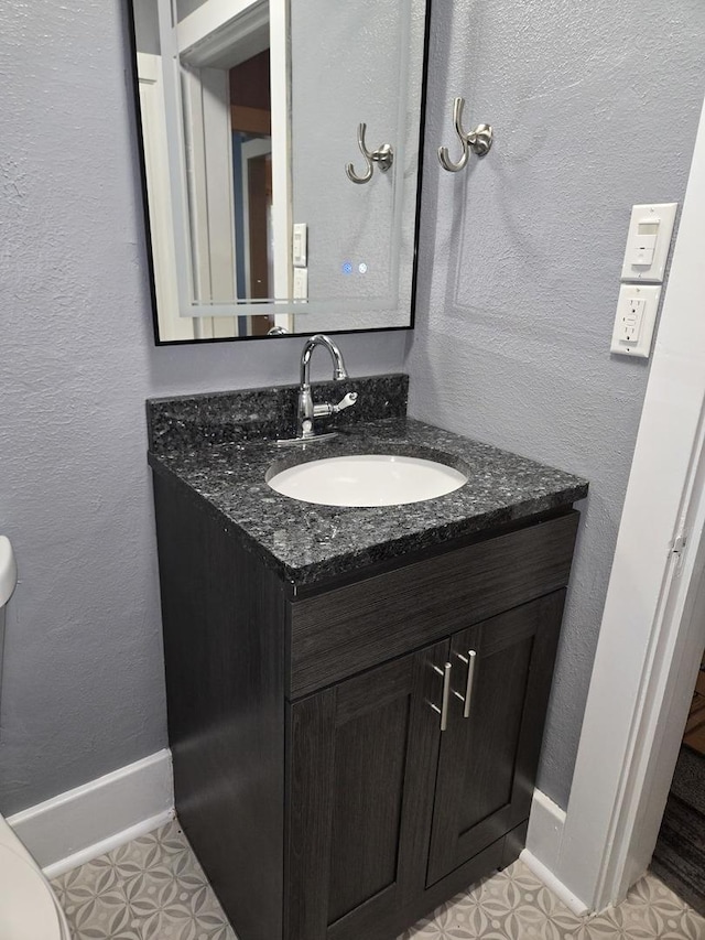 101 4th St, Fisher, IL 61843 - half bath featuring vanity, baseboards, toilet, and a textured wall