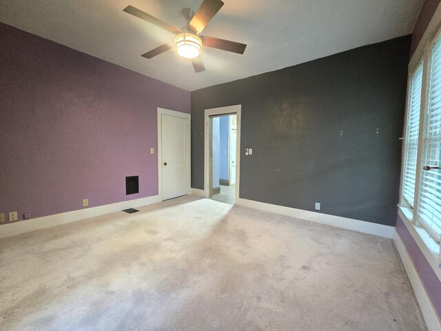 101 4th St, Fisher, IL 61843 - unfurnished room featuring ceiling fan, baseboards, light colored carpet, and plenty of natural light