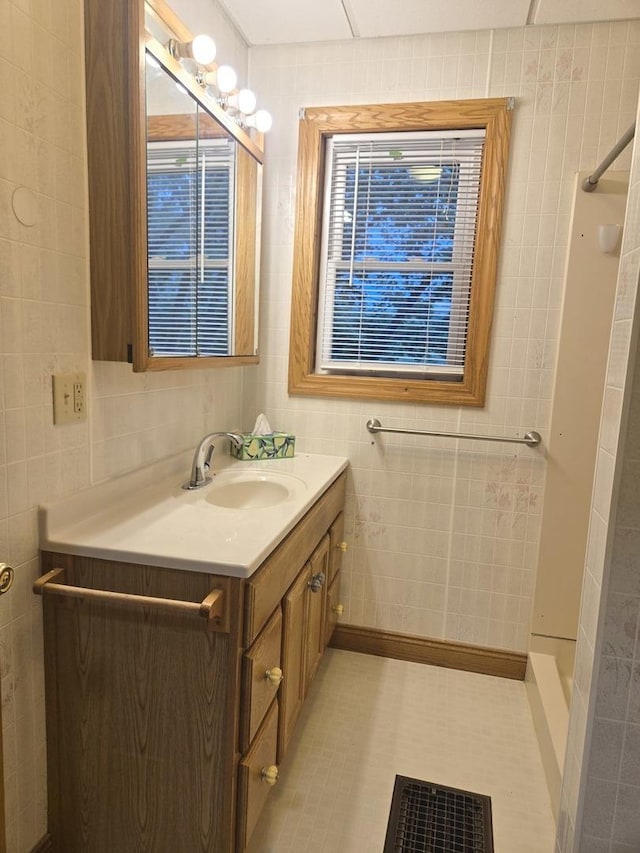 101 4th St, Fisher, IL 61843 - full bathroom featuring tile walls, vanity, and a shower