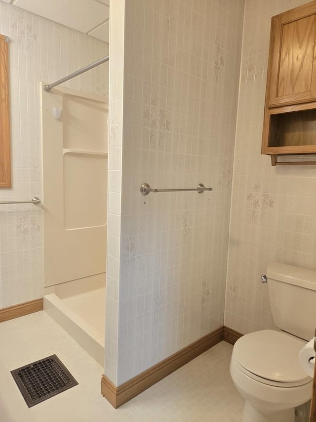 101 4th St, Fisher, IL 61843 - bathroom featuring a stall shower, toilet, and baseboards