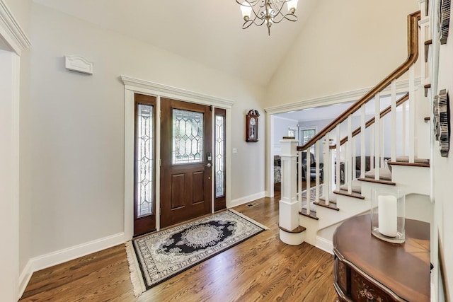 2041 Chatham Dr, Wheaton, IL 60189 - entryway featuring a chandelier, wood finished floors, stairway, baseboards, and high vaulted ceiling