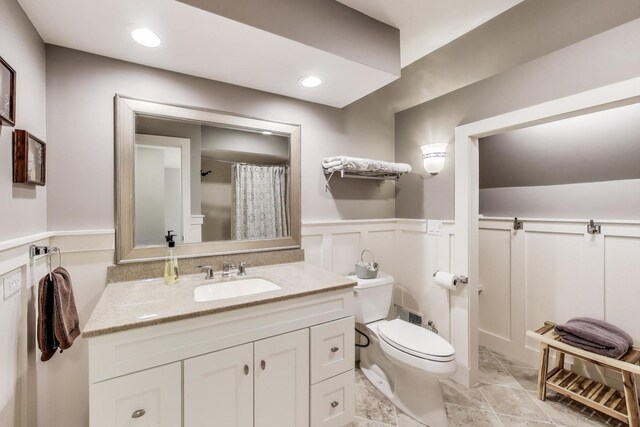 2041 Chatham Dr, Wheaton, IL 60189 - full bathroom with a wainscoted wall, toilet, vanity, a shower with shower curtain, and a decorative wall