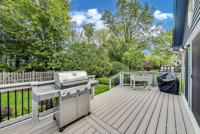 2041 Chatham Dr, Wheaton, IL 60189 - wooden deck featuring area for grilling, a shed, fence, an outdoor structure, and view of wooded area