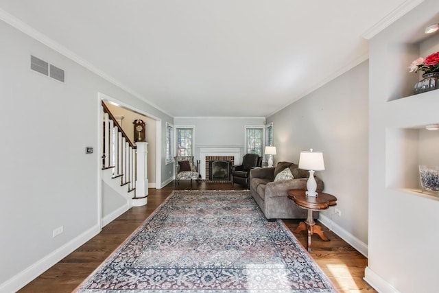 2041 Chatham Dr, Wheaton, IL 60189 - living room featuring stairs, a brick fireplace, dark wood finished floors, crown molding, and baseboards