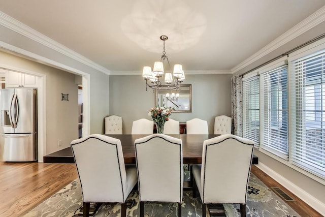 2041 Chatham Dr, Wheaton, IL 60189 - dining area with a chandelier, wood finished floors, ornamental molding, and baseboards
