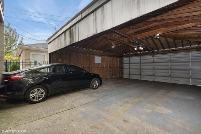 3934 W Argyle St Unit 3, Chicago, IL 60625 - garage featuring a garage door opener