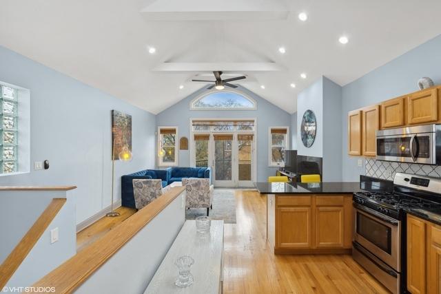 3934 W Argyle St Unit 3, Chicago, IL 60625 - kitchen featuring appliances with stainless steel finishes, healthy amount of natural light, light wood finished floors, open floor plan, and recessed lighting