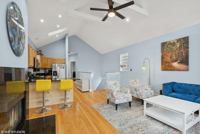 3934 W Argyle St Unit 3, Chicago, IL 60625 - living area with light wood-style flooring, ceiling fan, and lofted ceiling