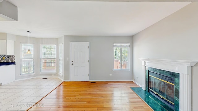 2135 Schumacher Dr, Naperville, IL 60540 - unfurnished living room featuring light wood finished floors, a fireplace, and baseboards