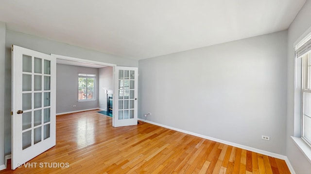 2135 Schumacher Dr, Naperville, IL 60540 - unfurnished room with french doors, light wood-style floors, and baseboards