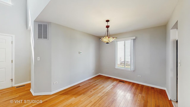 2135 Schumacher Dr, Naperville, IL 60540 - unfurnished room with light wood-type flooring, baseboards, and a chandelier