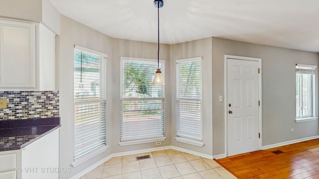2135 Schumacher Dr, Naperville, IL 60540 - unfurnished dining area featuring plenty of natural light and baseboards