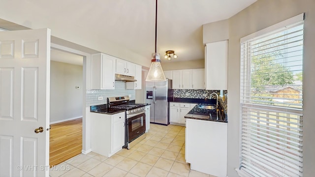 2135 Schumacher Dr, Naperville, IL 60540 - kitchen featuring appliances with stainless steel finishes, under cabinet range hood, a sink, backsplash, and white cabinets