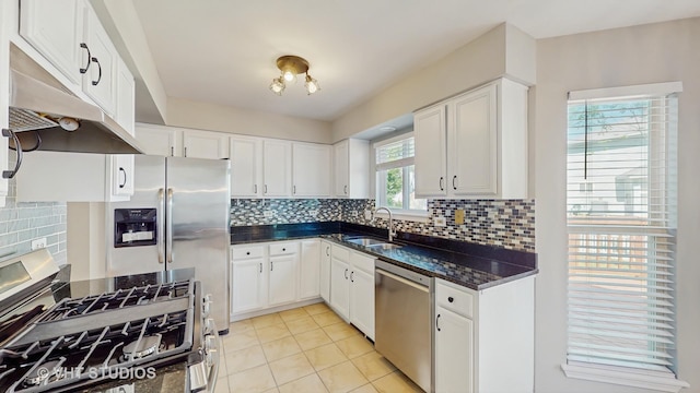 2135 Schumacher Dr, Naperville, IL 60540 - kitchen featuring stainless steel appliances, under cabinet range hood, a sink, light tile patterned floors, and white cabinetry