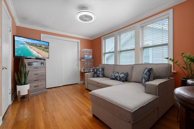 living room with light wood finished floors and ornamental molding