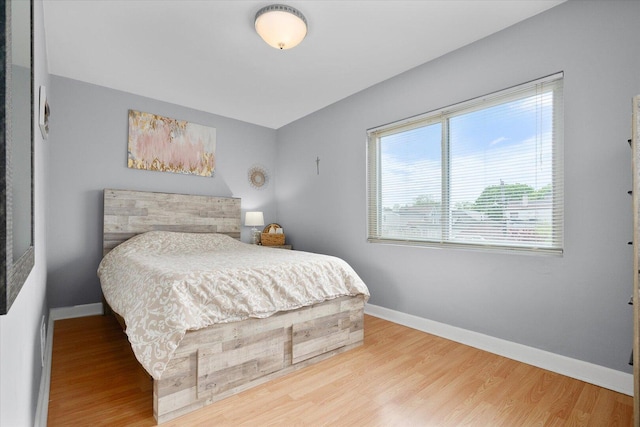 bedroom featuring baseboards and wood finished floors