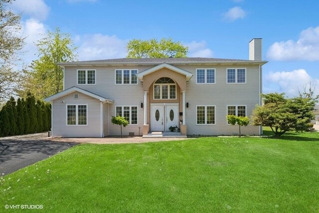 36 Chestnut Rd, Northbrook, IL 60062 - traditional home with a chimney and a front yard