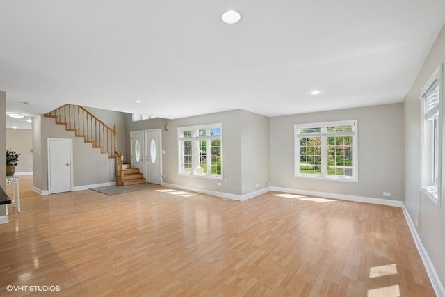 36 Chestnut Rd, Northbrook, IL 60062 - unfurnished living room featuring baseboards, stairway, and plenty of natural light