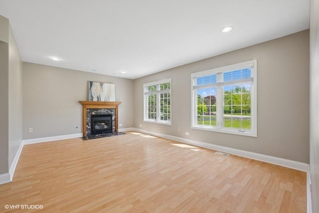 36 Chestnut Rd, Northbrook, IL 60062 - unfurnished living room with baseboards, light wood-style floors, a premium fireplace, and recessed lighting