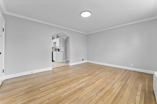 7133 W 16th St, Berwyn, IL 60402 - empty room with arched walkways, crown molding, light wood-style flooring, and baseboards