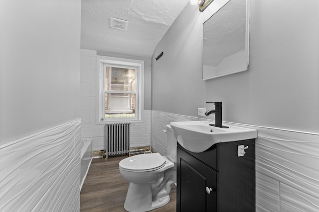 7133 W 16th St, Berwyn, IL 60402 - bathroom featuring radiator, toilet, vanity, wainscoting, and wood finished floors
