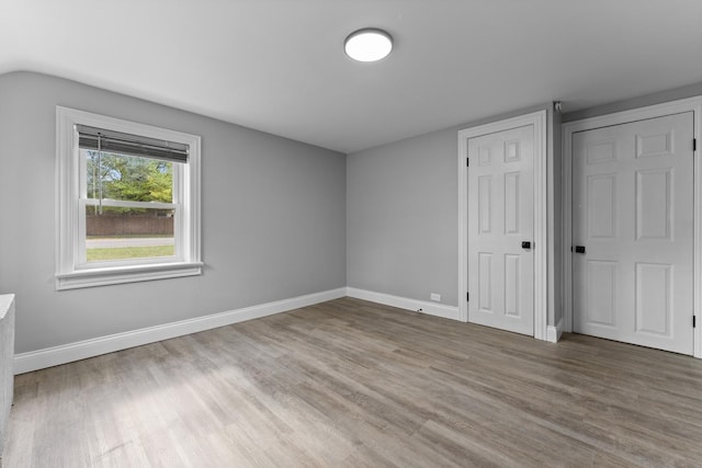 7133 W 16th St, Berwyn, IL 60402 - unfurnished bedroom featuring wood finished floors and baseboards