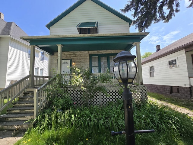 shotgun-style home featuring a porch