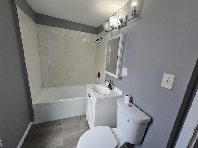 full bathroom featuring toilet, wood finished floors,  shower combination, and vanity