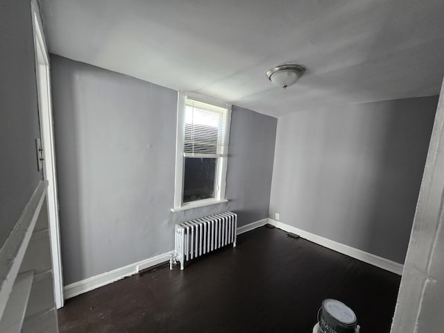 additional living space featuring radiator heating unit, baseboards, and wood finished floors