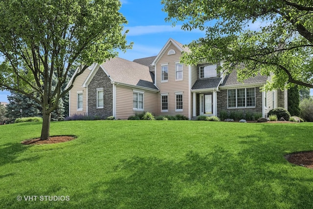 9310 Nicklaus Ln, Lakewood, IL 60014 - traditional home with stone siding, a front yard, and a shingled roof
