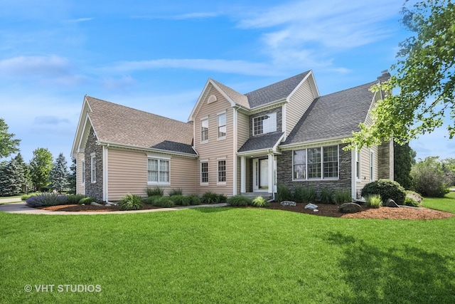 9310 Nicklaus Ln, Lakewood, IL 60014 - view of front of property featuring a front lawn, stone siding, a chimney, and a shingled roof