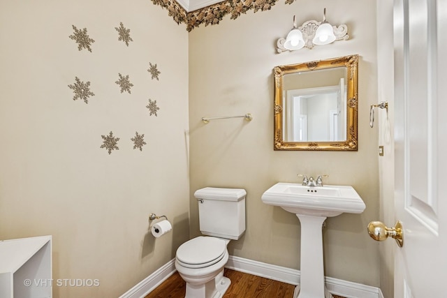 9310 Nicklaus Ln, Lakewood, IL 60014 - bathroom with baseboards, toilet, wood finished floors, and a sink