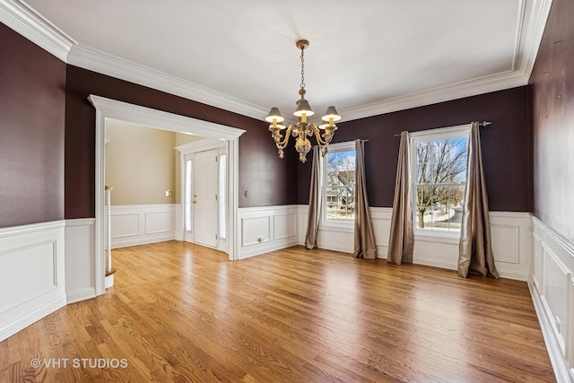 9310 Nicklaus Ln, Lakewood, IL 60014 - unfurnished dining area featuring a chandelier, wainscoting, light wood finished floors, ornamental molding, and a decorative wall