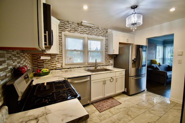 2837 18th St, North Chicago, IL 60064 - kitchen featuring stainless steel appliances, a sink, tasteful backsplash, white cabinets, and recessed lighting
