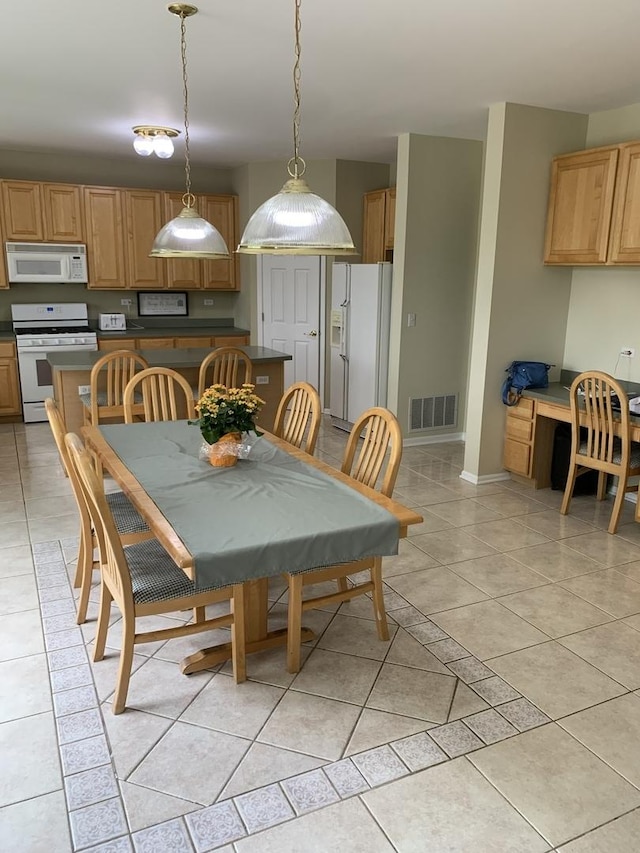 dining room with baseboards and light tile patterned floors
