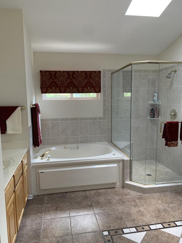 full bath featuring a garden tub, a shower stall, and vanity